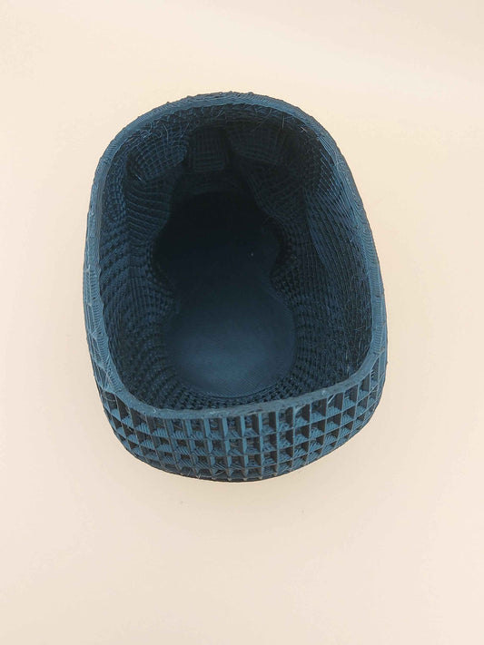 Overhead view looking into the deep cavity of the dark teal, woven-grid skull organizer.