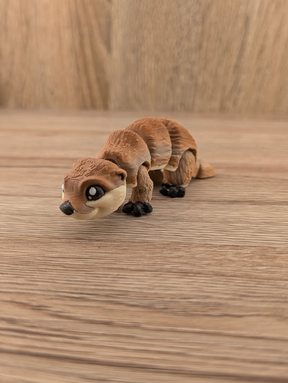 Low-angle view of a playful brown articulated animal figurine with layered texture, large eyes, and black feet.