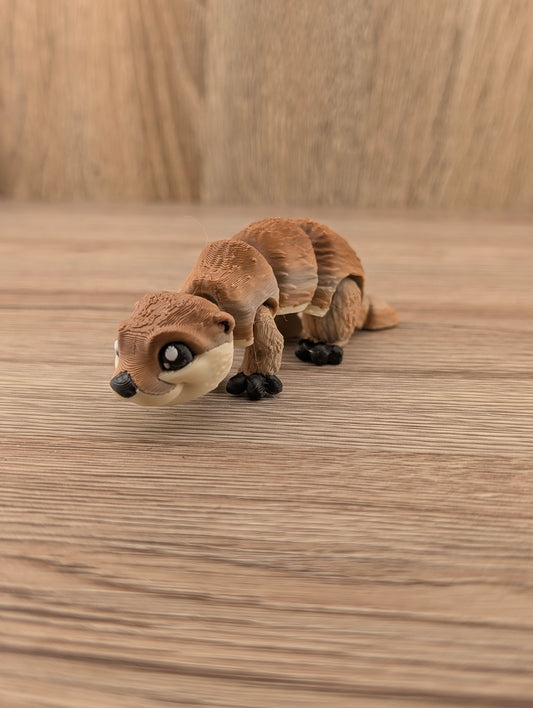 Low-angle view of a playful brown articulated animal figurine with layered texture, large eyes, and black feet.