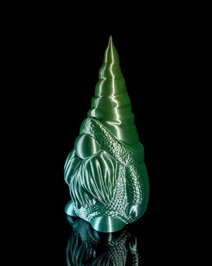 Three-quarter view of a green-to-teal colour shift gnome emphasising the shiny pointed hat and long beard.