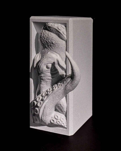 Close up, high-contrast view of the light grey kraken panel, showing detailed scales and suckers.