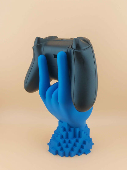 Rear profile of the controller holder. The black Xbox controller rests on the matte blue hand, viewed from the shoulder buttons.