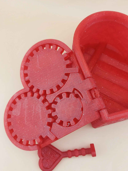 Close up view of the open sparkly red heart box lid, revealing the internal mechanical gears inside.