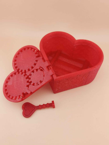 Wide shot of the open sparkly red heart box, showing the empty storage cavity and the geared locking mechanism lid.