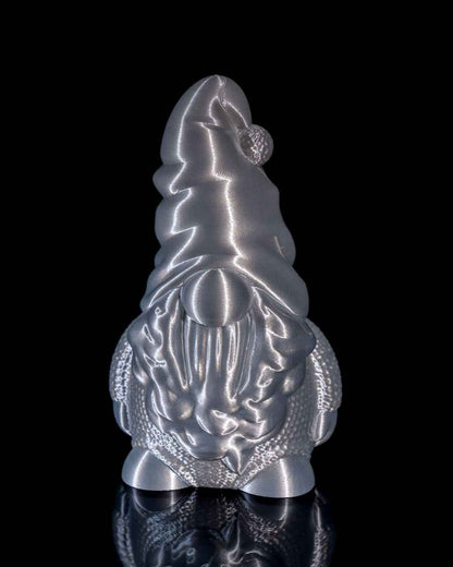 Front profile of a festive gnome figure with a pom-pom hat texture, highly reflective chrome silver finish.