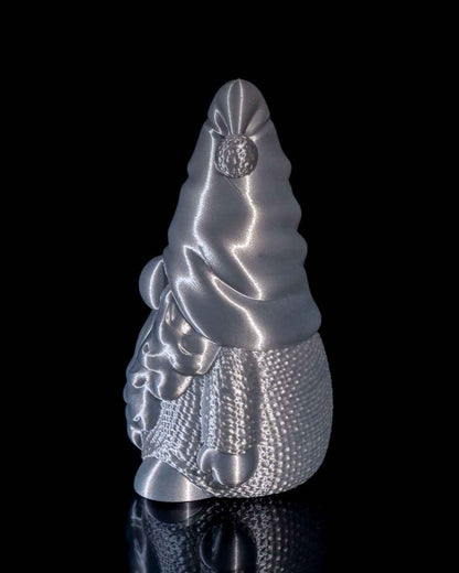 Side profile of a shiny silver gnome showing the textured woven body, detailed face, and outstretched glove.