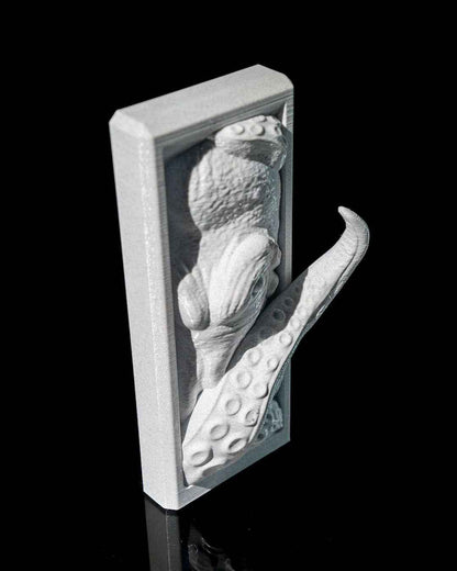 Oblique angle view of the textured silver kraken relief panel, emphasising the depth and projecting tentacle.