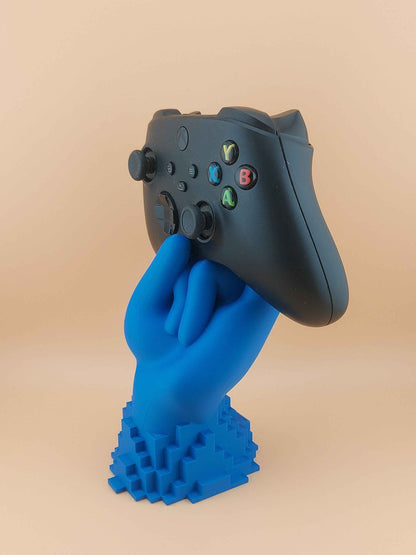 Close up of a black Xbox controller resting on the blue hand holder, emphasising the joysticks and D-pad.