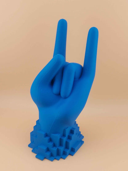 Slightly angled frontal view of the matte blue hand controller holder making the 'Rock On' symbol on a pixelated base.