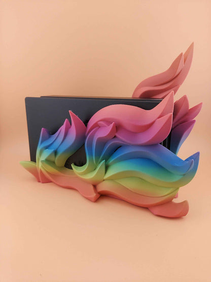 Full side view of a console dock decorated with smooth, matte rainbow flame , transitioning from pink to green.