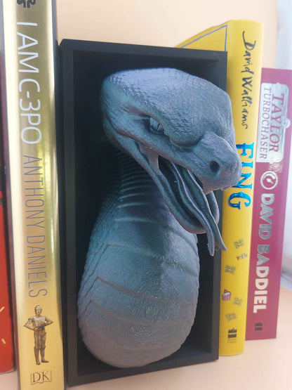 Profile view of the iridescent grey snake head angled down, showing pronounced neck ridges and scaled body texture.