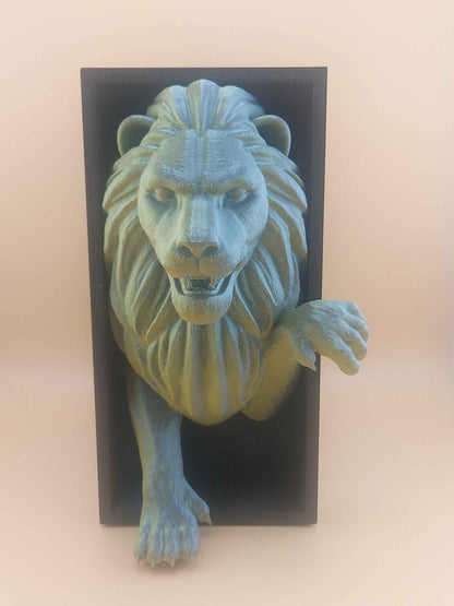 Straight frontal view of the detailed green-grey lion figure emerging from the black rectangular box.
