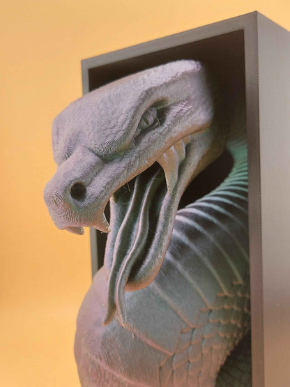 Dramatic high-angle close-up of the grey-purple snake head, emphasising the open mouth, coiled tongue, and snout.