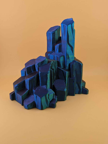 Angled view of the empty crystal stand, featuring sharp geometric facets and shifting colour from deep blue to bright teal green.