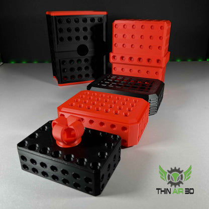 Black and red modular boxes stacked in various arrangements, illustrating the connectivity of the components.