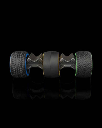 Side view showing three wheel attachment types: textured blue, smooth yellow, and green treaded.