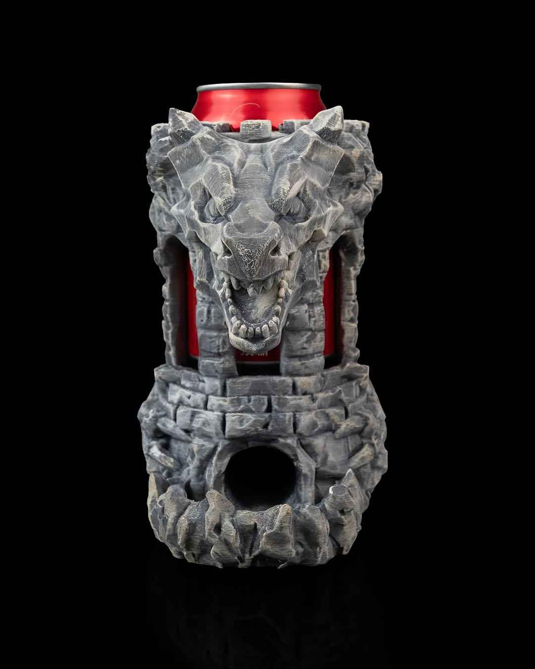 Straight front view of the menacing grey stone dragon head emerging from the tower can holder. Red can is visible inside.