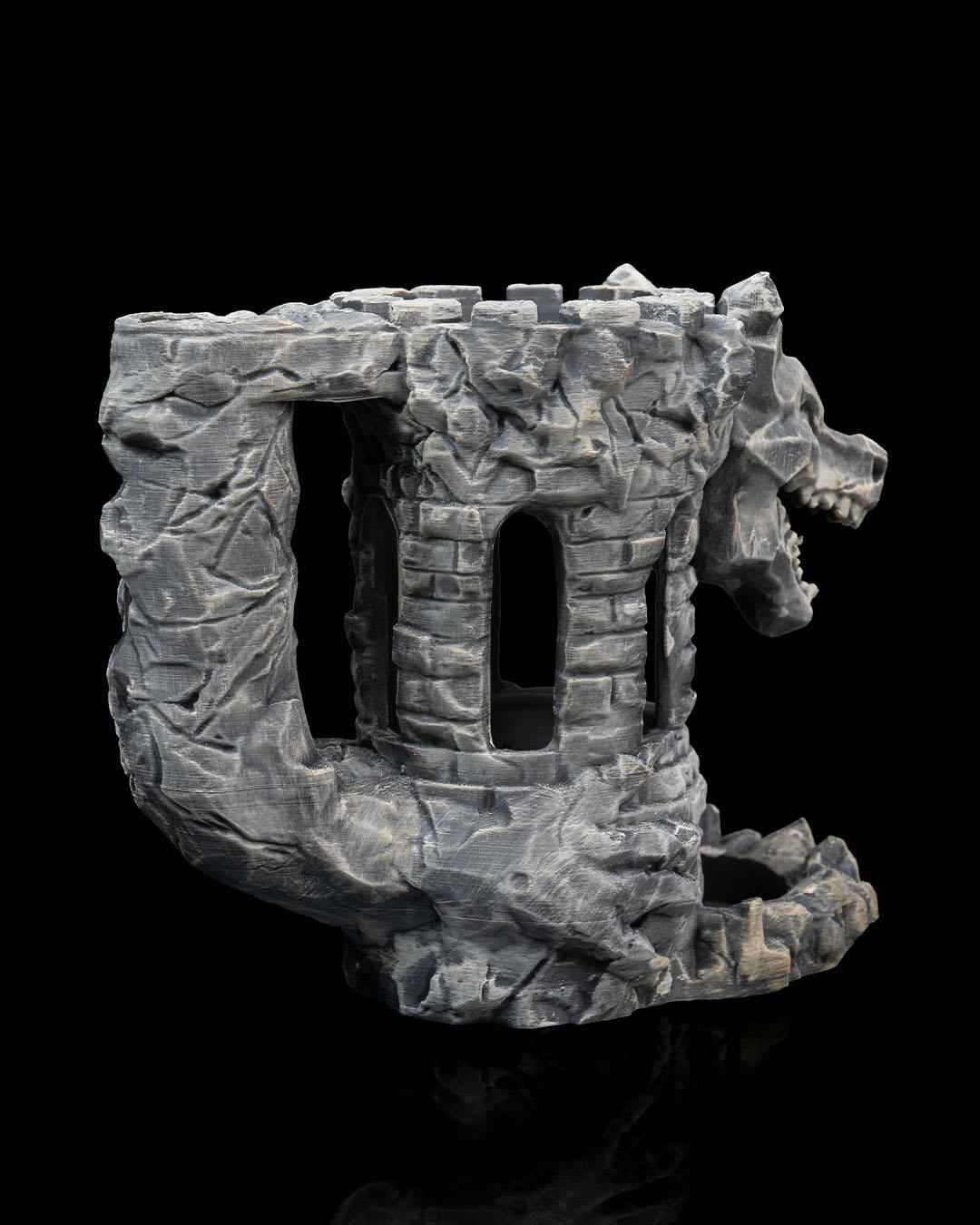 Low profile, side angle of the grey stone castle tower with rough, carved rock texture and windows.