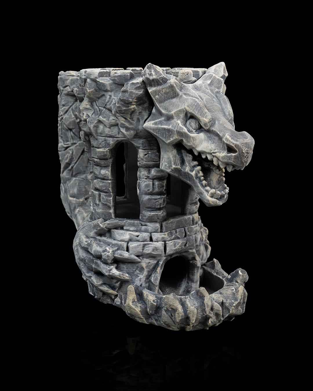 Angled 3/4 view of the tall grey stone tower with intense rock texture. The dragon head juts out over the lower rampart.