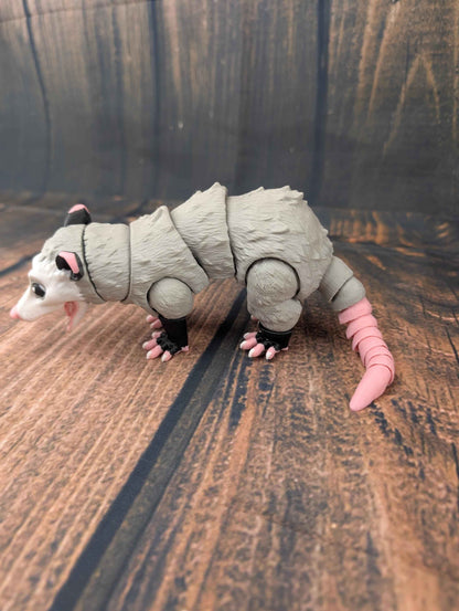 Full side profile of the articulated grey opossum figure standing, showing jointed limbs and torso.