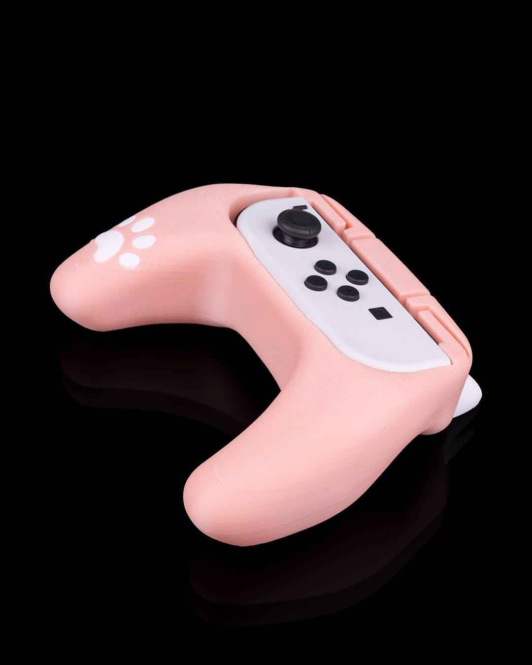 45-degree angled view of the curved pink grip accessory showing the inserted white right joycon with buttons.