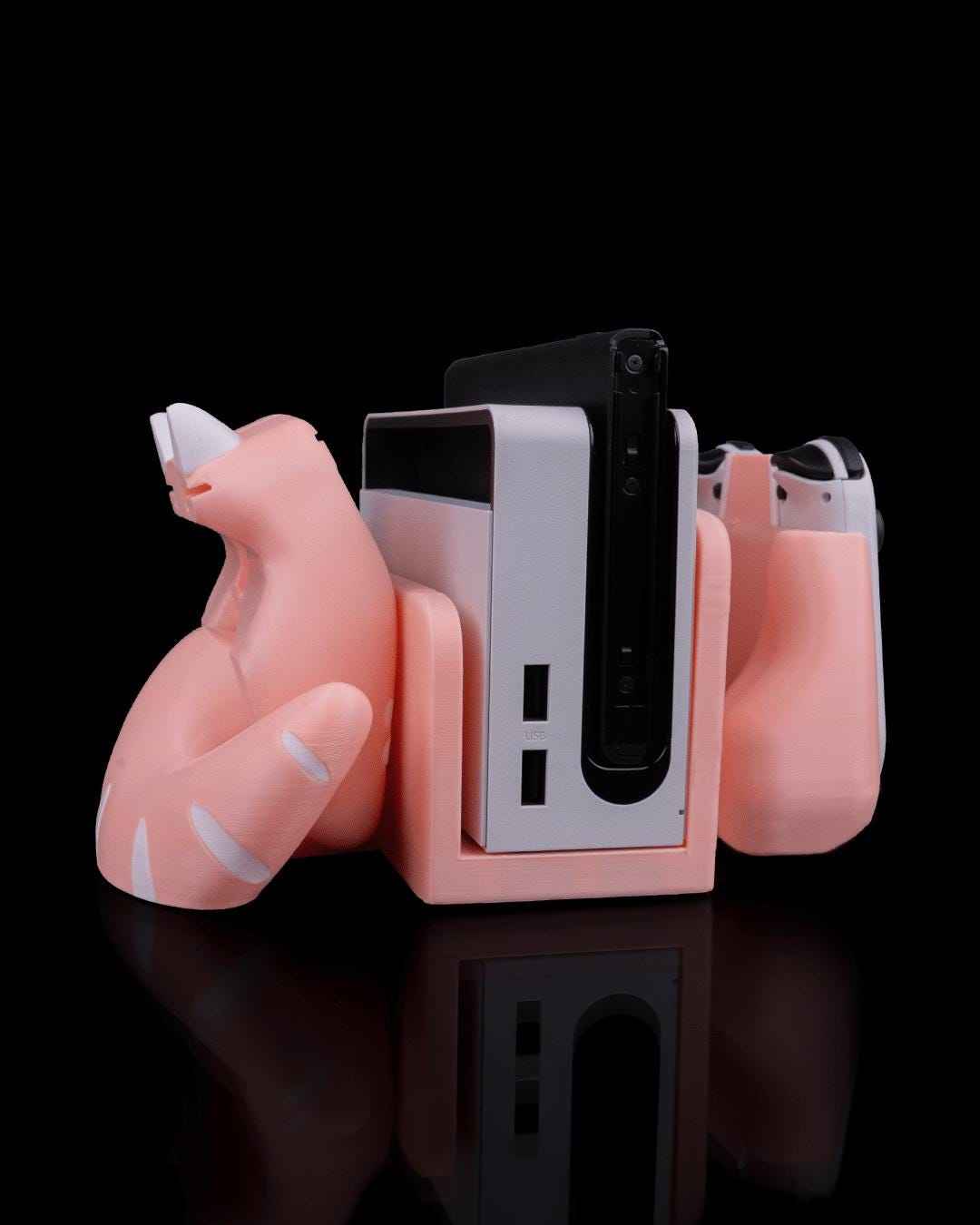 Angled side/rear view of the matte peach cat dock. A white striped tail curls around the main console dock.