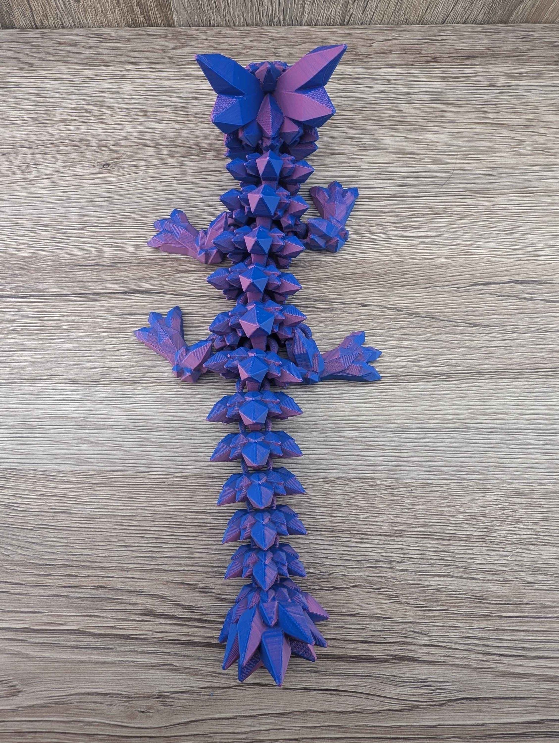 Top-down view of the articulated blue and purple crystal dragon, showcasing the full length and complex spiky texture.