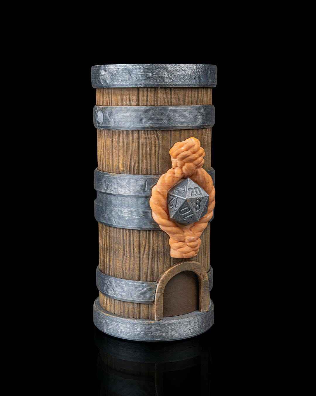 Angled front view of the wood grain barrel dice tower with silver hoops and a detailed orange rope knot holding a silver D20.