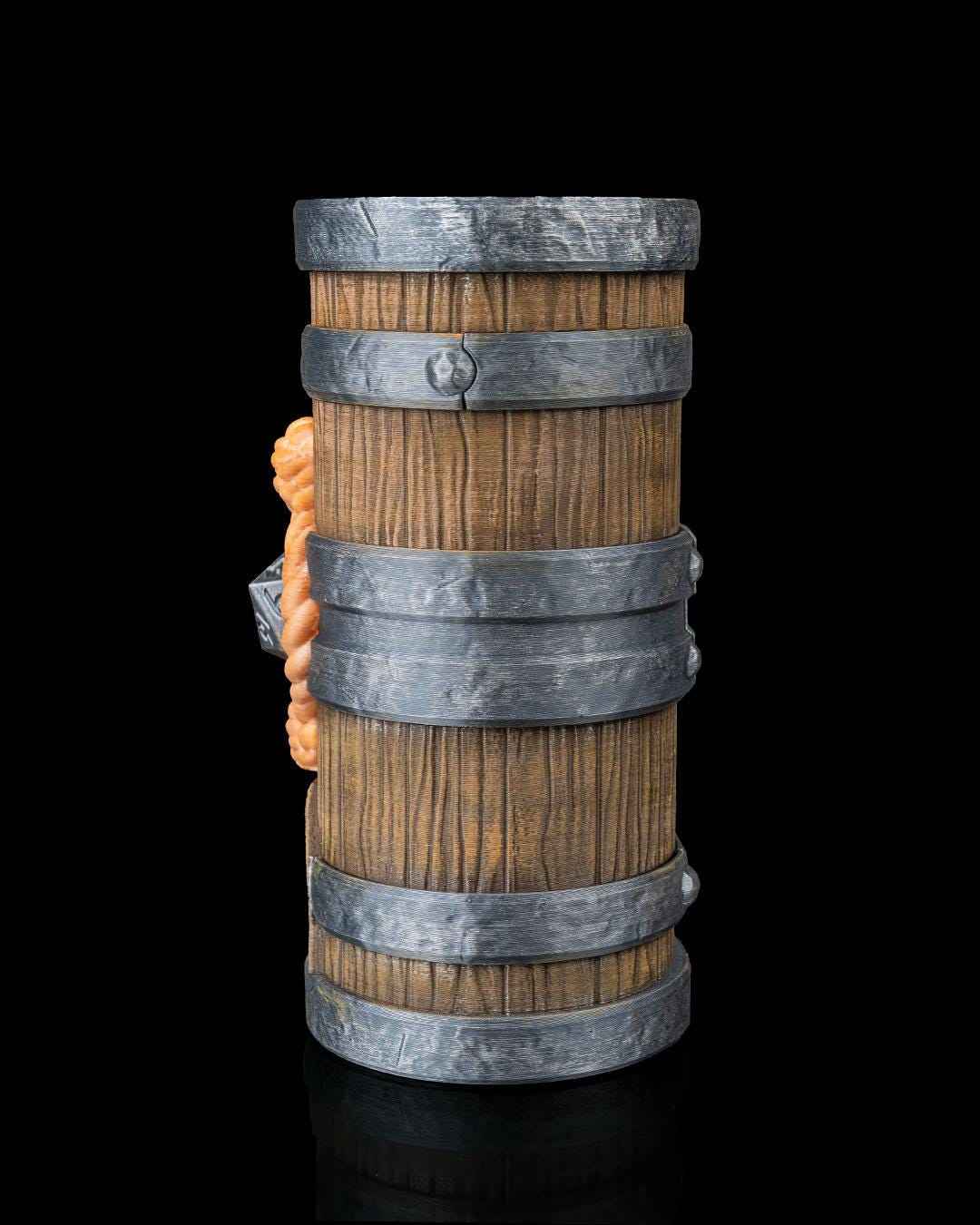 Side profile of the weathered wood barrel. Silver hoops are textured and riveted, with the orange rope knot partially visible.