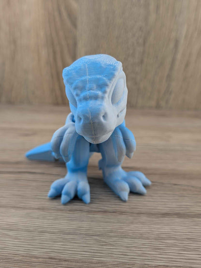 Low angle, centred front view of the matte blue dinosaur figure, emphasising the feet and snout.