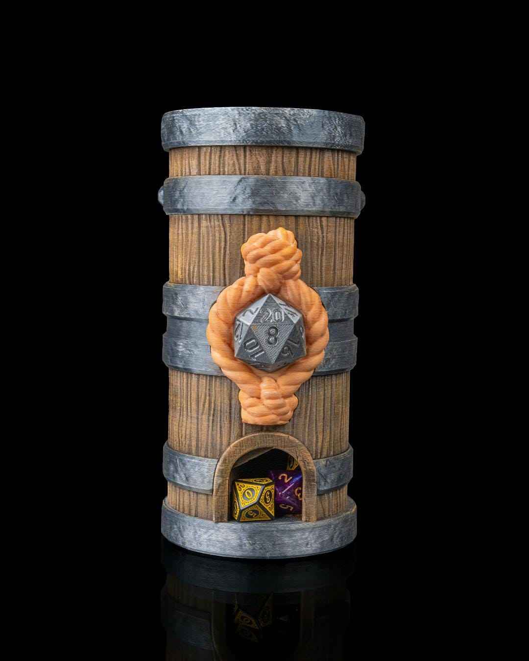 Weathered wood barrel dice tower with silver hoops. Front view showing orange rope knot, silver D20, and dice in the exit.
