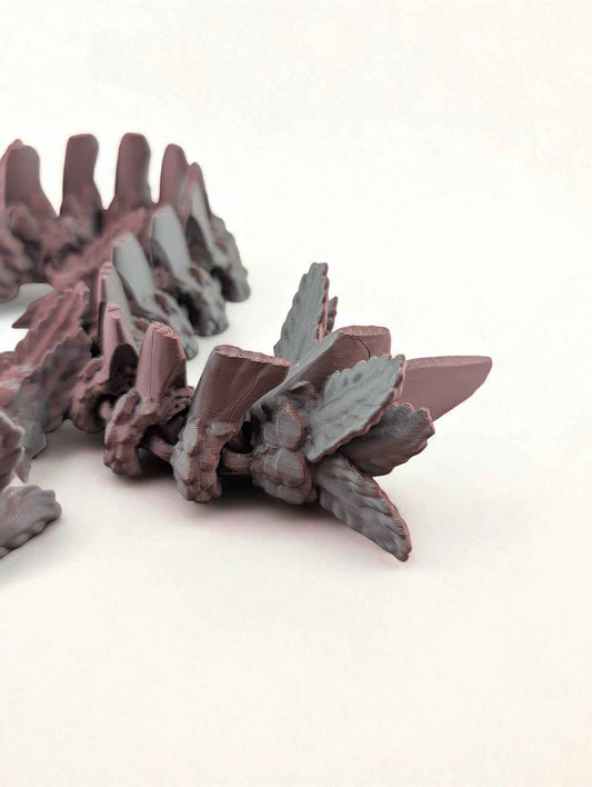 Extreme close-up of the segmented, matte dragon tail, highlighting the rough, textured side fins.