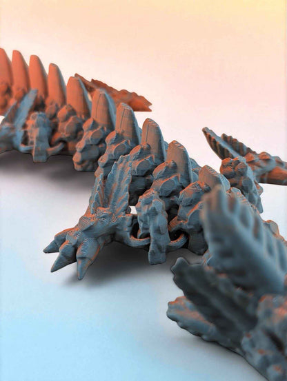 Shallow depth of field shot highlighting the blue body texture and the vibrant orange dorsal fins rising sharply.
