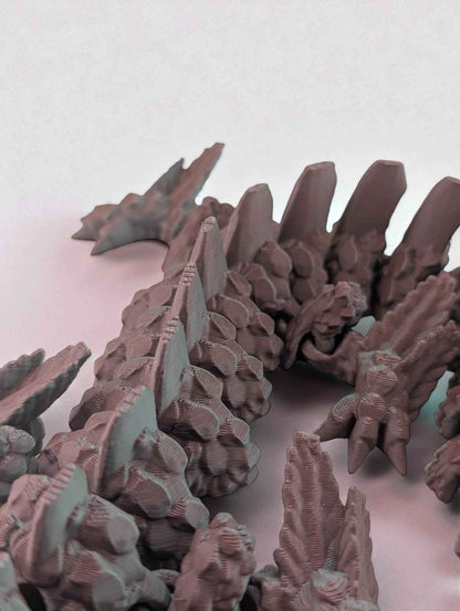 Side view focusing on the spine: large dorsal fins rise from the articulated body's rocky, jagged texture.