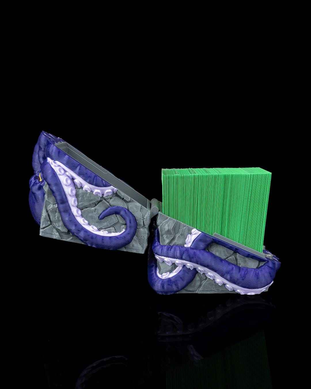 Open octopus-themed box revealing a stack of vibrant neon green card sleeves inside the gray storage compartment.