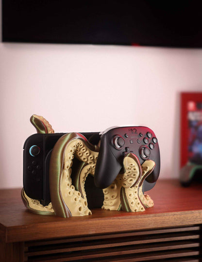 Olive and bronze kraken stand holds a black Nintendo Switch console and a matching Pro Controller.