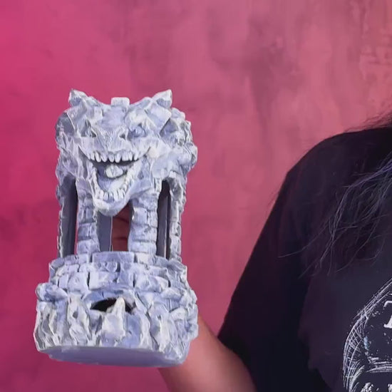 Dungeons and Dragons player rolling a d20 through the Dragon Fortress tower.