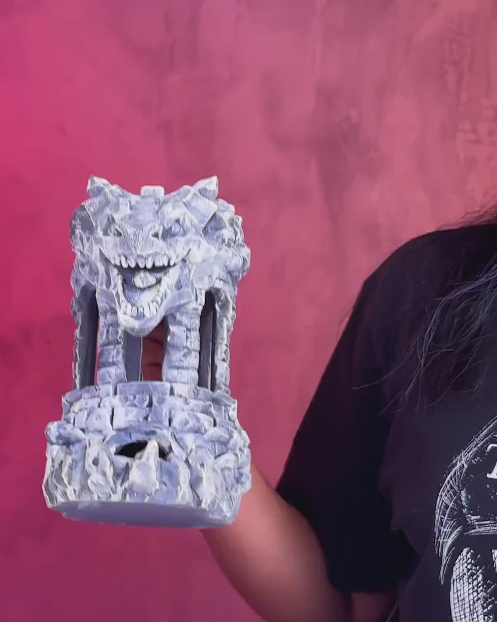 Dungeons and Dragons player rolling a d20 through the Dragon Fortress tower.